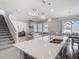 Open-concept kitchen with stainless steel sink, adjacent living room and staircase at 2279 Raven Ridge Road, Minneola, FL 34715