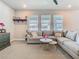 Comfortable living room featuring a large sectional sofa and a decorative display shelf at 2279 Raven Ridge Road, Minneola, FL 34715