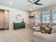 Cozy living room filled with neutral toned furniture, a ceiling fan and natural light through multiple windows at 2279 Raven Ridge Road, Minneola, FL 34715