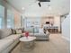 Bright living room showcasing a large sectional sofa and seamless flow into the modern kitchen at 2279 Raven Ridge Road, Minneola, FL 34715