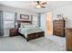 This main bedroom features wood furnishings, windows for natural light, and an ensuite bathroom at 2279 Raven Ridge Road, Minneola, FL 34715
