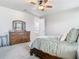 Comfortable main bedroom with warm wood furniture and bright, airy feel at 2279 Raven Ridge Road, Minneola, FL 34715