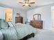 This main bedroom features wood furnishings, windows for natural light, and an ensuite bathroom at 2279 Raven Ridge Road, Minneola, FL 34715