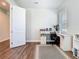 Bright office space featuring a built-in desk, stylish decor, and hardwood flooring at 2279 Raven Ridge Road, Minneola, FL 34715