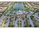 Aerial shot of the community with a large lake, pool, tennis courts, and clubhouse at 2408 Dubai St, Kissimmee, FL 34747