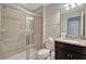 Bathroom showcasing a single sink with granite countertop, dark cabinets and glass-enclosed shower at 2408 Dubai St, Kissimmee, FL 34747