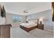 Bedroom with ceiling fan, gray walls, and mounted television at 2408 Dubai St, Kissimmee, FL 34747