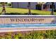A water feature with landscaping displaying the Windsor at Westside community sign at 2408 Dubai St, Kissimmee, FL 34747