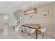 Cozy dining area with modern lighting fixture, next to staircase and front entrance at 2408 Dubai St, Kissimmee, FL 34747