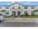 Charming townhome featuring a well-maintained exterior, front yard landscaping, and inviting entrance at 2408 Dubai St, Kissimmee, FL 34747