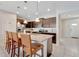 Well-equipped kitchen with granite countertops, stainless steel appliances, and breakfast bar seating at 2408 Dubai St, Kissimmee, FL 34747