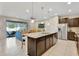 Gourmet kitchen with an expansive island bar, stainless steel appliances, and open-concept layout at 2408 Dubai St, Kissimmee, FL 34747