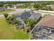 Home featuring solar panels, screened-in pool, palm trees, landscaping, and a fenced-in backyard at 3037 Diamond Ln, St Cloud, FL 34772