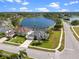 Aerial view of home with screened-in pool overlooking a large pond in a serene neighborhood at 3037 Diamond Ln, St Cloud, FL 34772