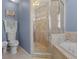 Bathroom with glass shower, soaking tub, and beige tile at 3037 Diamond Ln, St Cloud, FL 34772