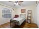 Bedroom featuring hardwood floors, natural light, and a reading chair at 3037 Diamond Ln, St Cloud, FL 34772