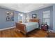 Bedroom with hardwood floors, blue walls, and natural light through the window at 3037 Diamond Ln, St Cloud, FL 34772