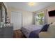 Bedroom with hardwood floors, closet and a window overlooking the yard at 3037 Diamond Ln, St Cloud, FL 34772