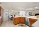 Bright kitchen has wood cabinets, white countertops, stainless steel appliances, and a sunlit breakfast nook at 3037 Diamond Ln, St Cloud, FL 34772