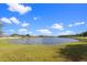 Beautiful lake in a lush neighborhood with landscaped green space and manicured trees at 3037 Diamond Ln, St Cloud, FL 34772