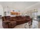 Open concept living room with tile floors, view to the kitchen, breakfast nook, and screened in patio at 3037 Diamond Ln, St Cloud, FL 34772