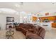 Open concept living room with tile floors, view to the kitchen, breakfast nook, and plenty of seating at 3037 Diamond Ln, St Cloud, FL 34772