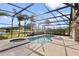 Enclosed pool and hot tub area with view of the lake at 3037 Diamond Ln, St Cloud, FL 34772