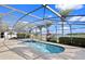 The screened-in pool and patio overlook a peaceful pond at 3037 Diamond Ln, St Cloud, FL 34772