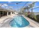 Screened-in pool with a hot tub and a view of the backyard pond at 3037 Diamond Ln, St Cloud, FL 34772
