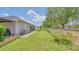 Backyard featuring a well maintained lawn and trees along a perimeter wall at 3191 Marshfield Preserve Way, Kissimmee, FL 34746
