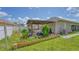Backyard featuring a pergola, outdoor seating, and well-manicured plants and lawn at 3191 Marshfield Preserve Way, Kissimmee, FL 34746
