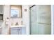 Bathroom featuring gray vanity and glass-door shower at 3191 Marshfield Preserve Way, Kissimmee, FL 34746