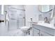 Bathroom featuring a vanity with chrome faucet, shower, and a round mirror at 3191 Marshfield Preserve Way, Kissimmee, FL 34746