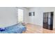Well-lit bedroom featuring wood floors, a window with curtains and a mounted flat screen TV at 3191 Marshfield Preserve Way, Kissimmee, FL 34746