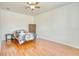 Clean and bright bedroom with hardwood floors and a ceiling fan for added comfort at 3191 Marshfield Preserve Way, Kissimmee, FL 34746