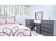 Bedroom with bed, dresser, and decorative hanging vines at 3191 Marshfield Preserve Way, Kissimmee, FL 34746