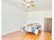 Bright bedroom with hardwood floors, a ceiling fan, and closet space for storage at 3191 Marshfield Preserve Way, Kissimmee, FL 34746