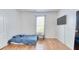 Bright bedroom with wood floors, a window with curtains and a wall-mounted TV at 3191 Marshfield Preserve Way, Kissimmee, FL 34746