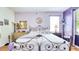 Comfortable bedroom features a large window and a stylish purple color scheme at 3191 Marshfield Preserve Way, Kissimmee, FL 34746