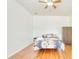 Spacious bedroom featuring hardwood floors, a ceiling fan, and ample natural light at 3191 Marshfield Preserve Way, Kissimmee, FL 34746