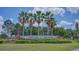 Community entrance to Parkview at Lake Shore features lush landscaping and swaying palm trees at 3191 Marshfield Preserve Way, Kissimmee, FL 34746
