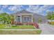 Charming single-story home with lush landscaping, an inviting entrance, and a well-maintained lawn at 3191 Marshfield Preserve Way, Kissimmee, FL 34746