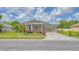 Inviting single-story home with lush landscaping, a vibrant entrance, and a well-maintained lawn at 3191 Marshfield Preserve Way, Kissimmee, FL 34746