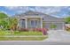 Charming single-Gathering home featuring a well-manicured lawn and a three-car garage at 3191 Marshfield Preserve Way, Kissimmee, FL 34746