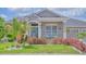 Inviting home featuring a cozy front porch with seating and a decorative front door at 3191 Marshfield Preserve Way, Kissimmee, FL 34746