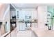 Bright kitchen features white cabinets, stainless steel appliances, and a tile floor at 3191 Marshfield Preserve Way, Kissimmee, FL 34746