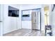 Kitchenette with stainless steel refrigerator and white cabinets at 3191 Marshfield Preserve Way, Kissimmee, FL 34746