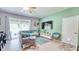 A comfortable living area features a sectional sofa, TV, and sliding glass doors to the outdoors at 3191 Marshfield Preserve Way, Kissimmee, FL 34746
