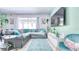 Cozy living area with a sectional sofa, modern TV, and a view of the outdoor space at 3191 Marshfield Preserve Way, Kissimmee, FL 34746