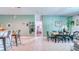 Open-concept living area features a dining table, bar seating, and doorway to another room at 3191 Marshfield Preserve Way, Kissimmee, FL 34746